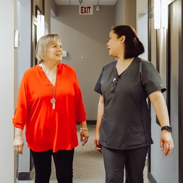 Dentistry team member talking to dental patient