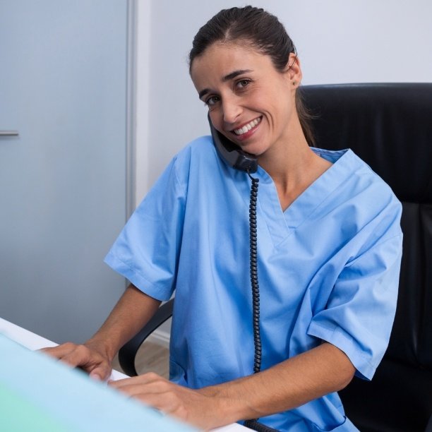 Friendly dental team member answering the phone