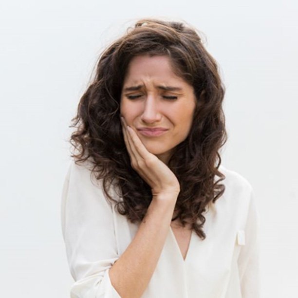 Grimacing woman, in pain from a toothache