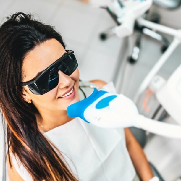 Dental patient receiving teeth whitening