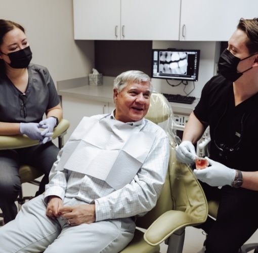 smiling man talking to dentist
