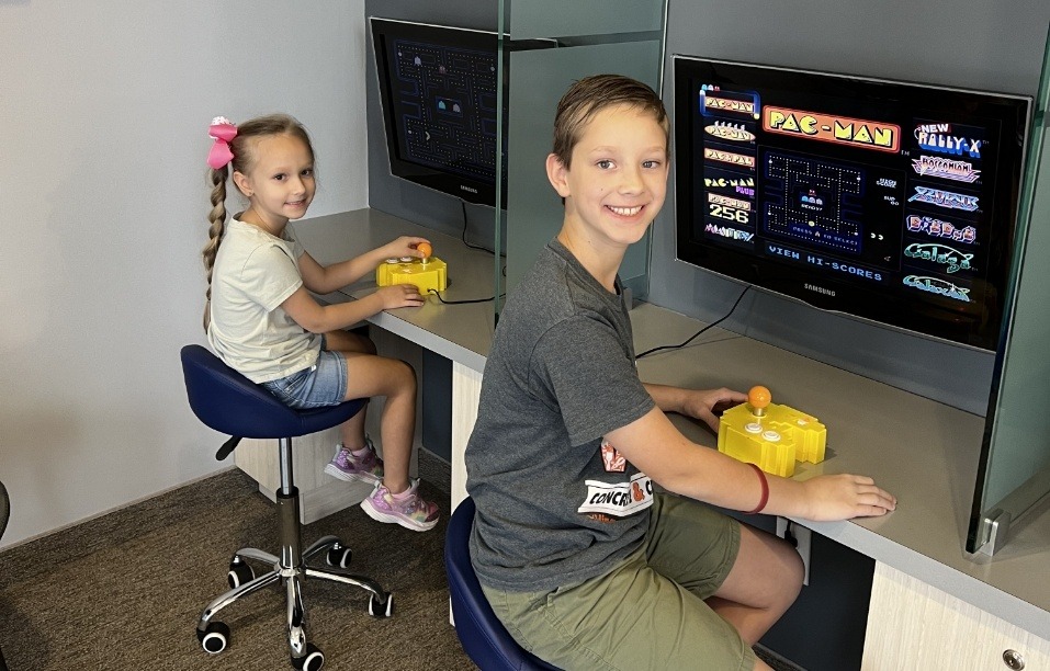 Kids playing video games in dental office waiting room