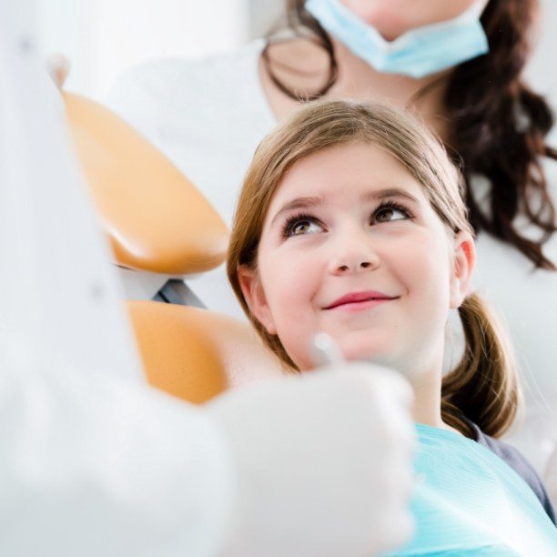 Child smiling at dentist during children's dentistry visit