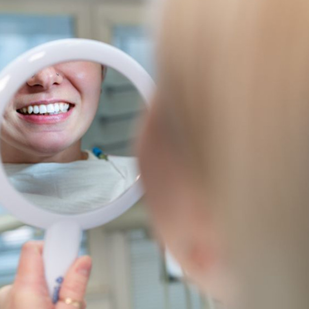 Patient’s beautiful teeth reflected in mirror