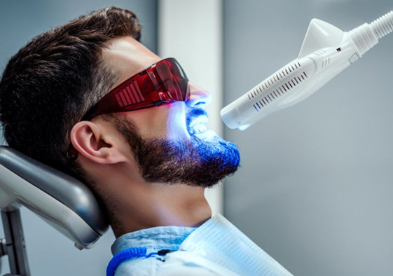 Man undergoing in-office teeth whitening treatment