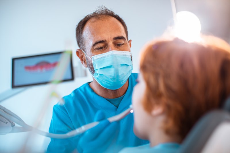Dentist working on young patient.