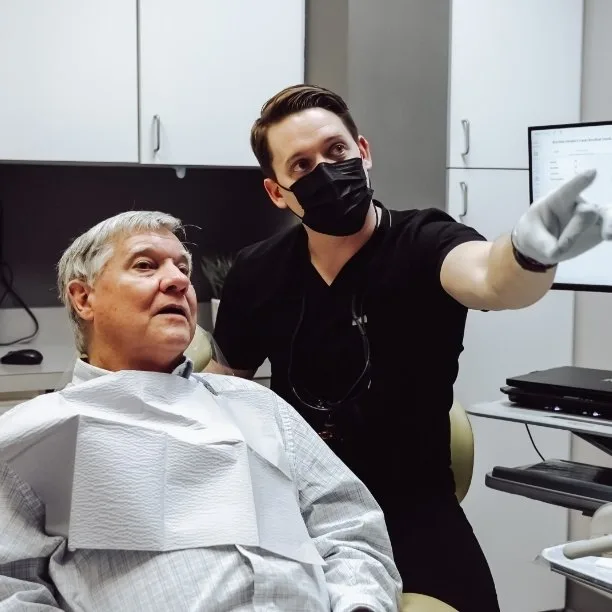 Dr. Hardin reviewing dental X-rays with a long-standing patient