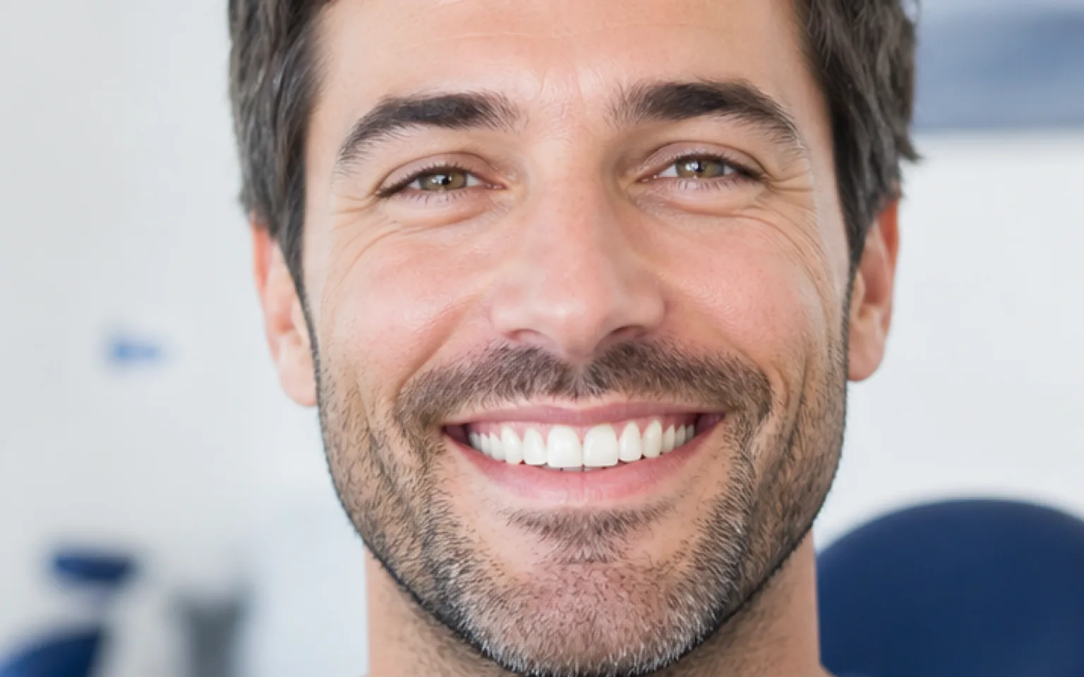 Woman sitting in a dental chair and smiling