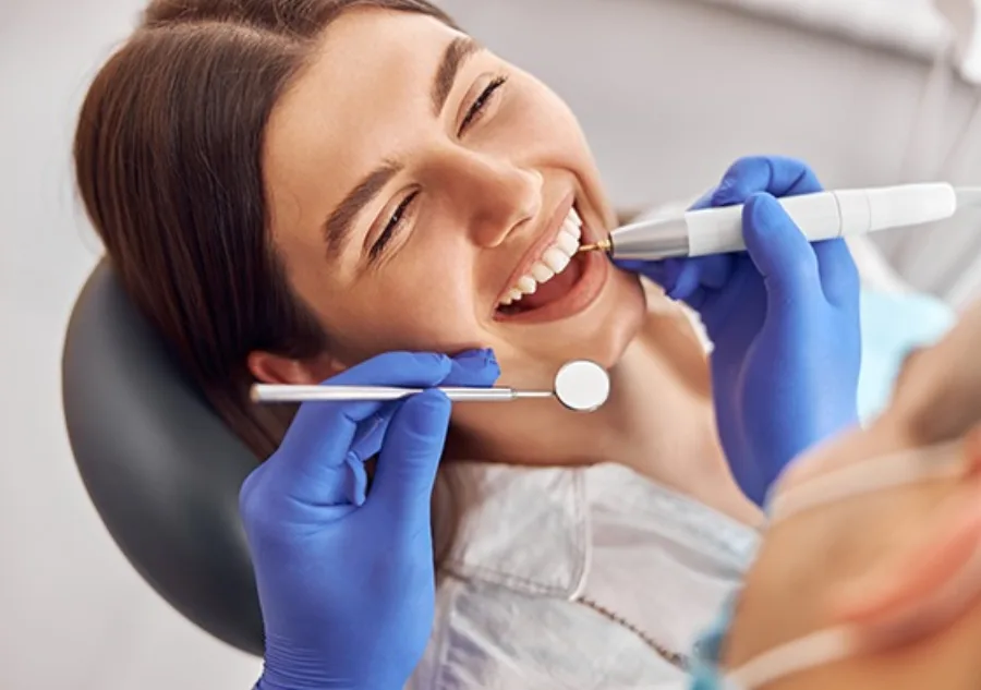 A young woman receiving a dental checkup from her dentist
