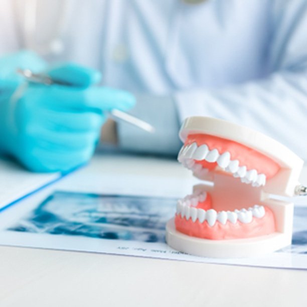 Dentist in Plano working on a patient’s denture
