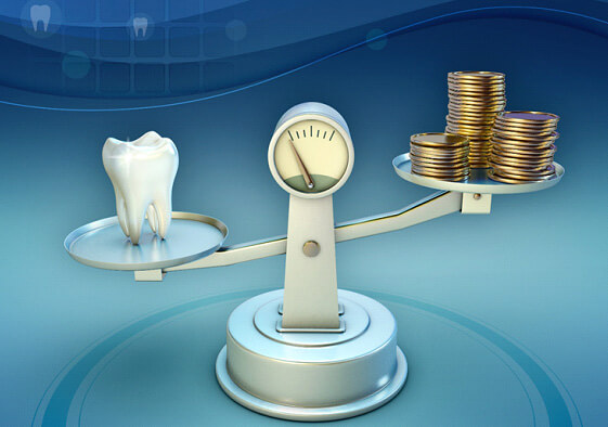 tooth and coins on a balance scale